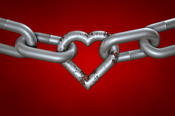 Chain with rusty heart on red background. Even rusty, the hart is still important part of the love chain. Clipping path included.