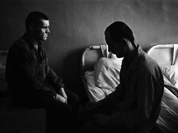Фото Сергея Склярова. Мужчины сидят друг напротив друга на кушетках в больнице