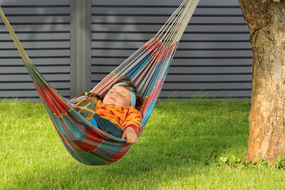 Little girl having a rest in a hammock