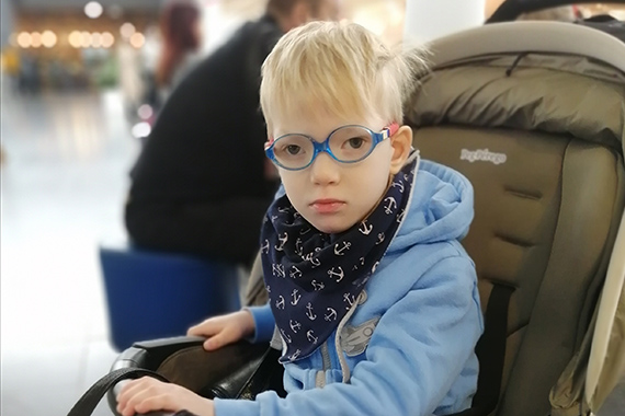 Мальчик в очках в коляске