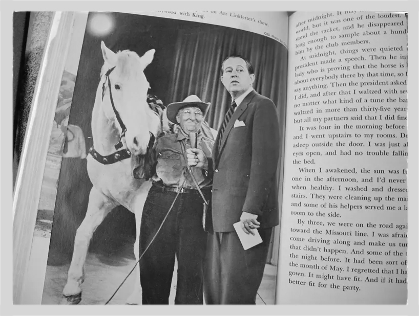 Фотография страницы из книги, где Энни Уилкинс держит лошадь под уздцы и дает интервью