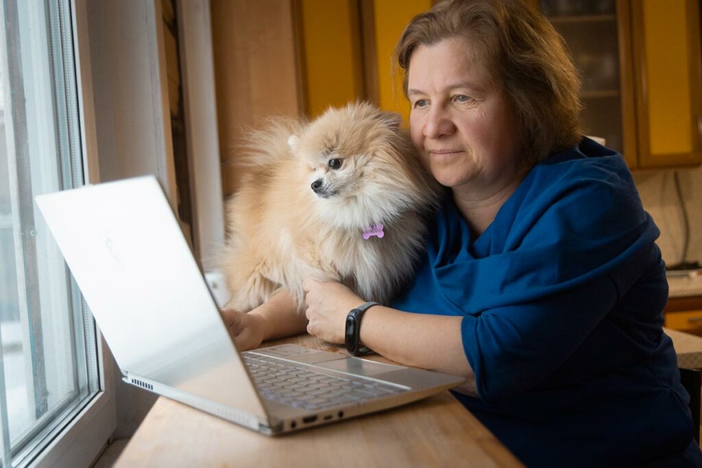 Ольга за ноутбуком с домашней собачкой