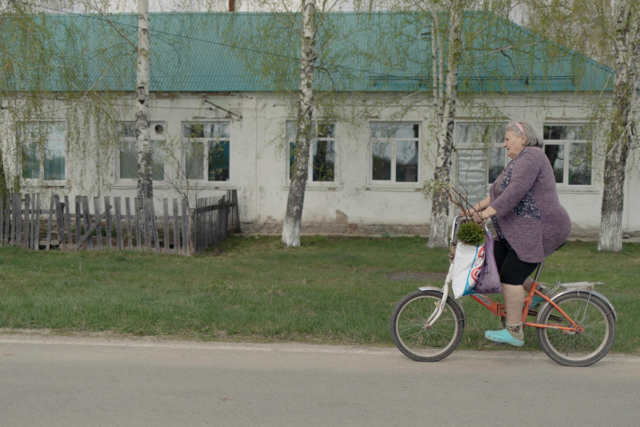 Женщина на велосипеде едет по улице