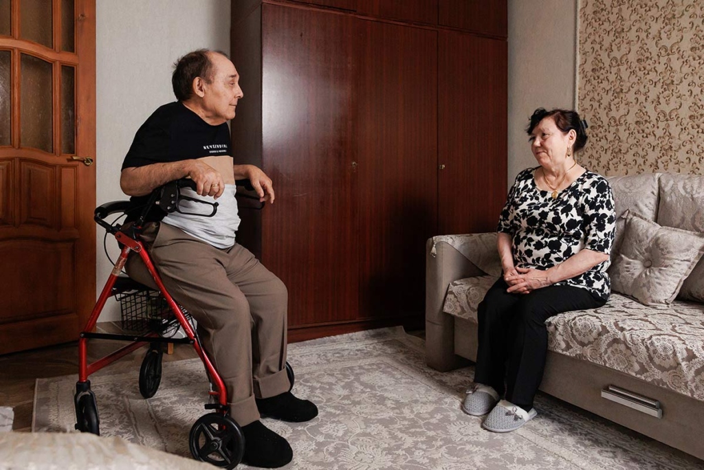 Мужчина на каталке и женщина в комнате