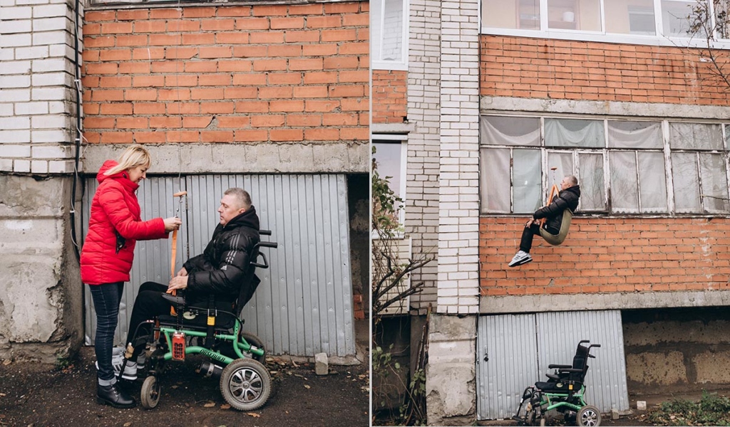 Мужчина на лебедке спускается с балкона