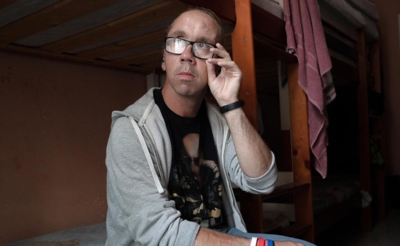 Мужчина сидит на кровати