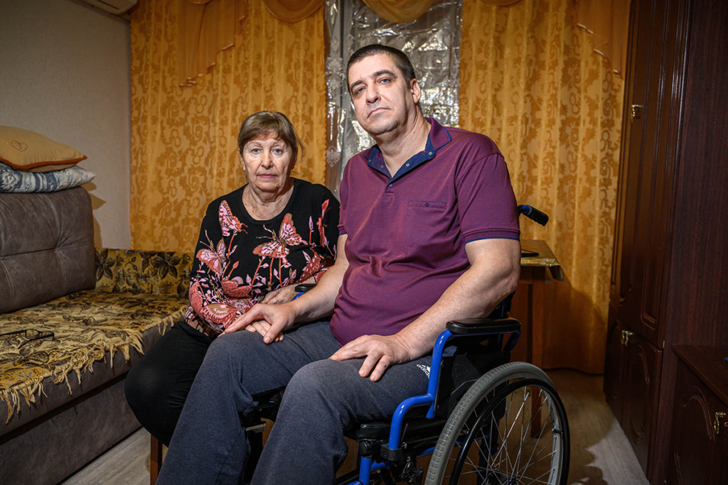 Мужчина на инвалидной коляске, рядом его мама