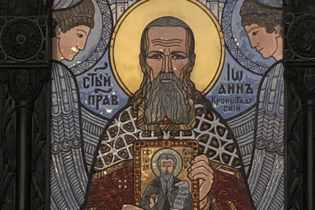 Иоанн Кронштадтский с иконой своего небесного покровителя преподобного Иоанна Рыльского. Изображение на дверях Морского Никольского собора Кронштадта